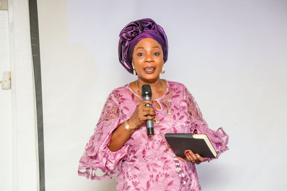Speaker addressing the room with a handheld microphone